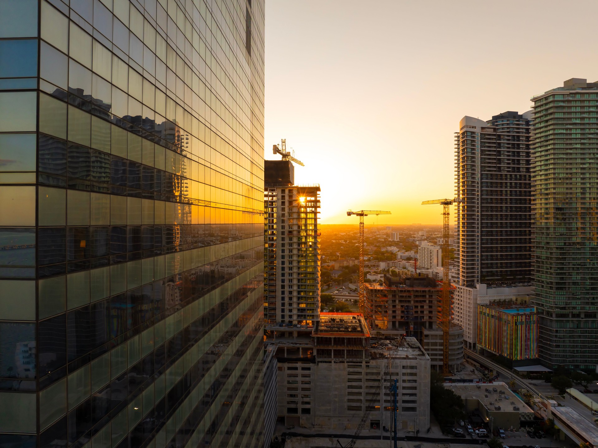 New construction site in Miami, Florida au sunset. Developing residence in American urban area. Concept of housing growth in the USA
